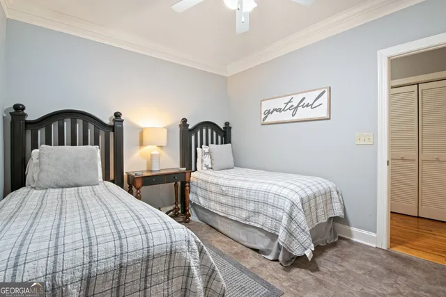 a bedroom with two beds and a night stand