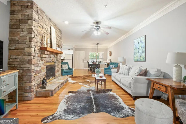 a living room with fireplace furniture and a rug