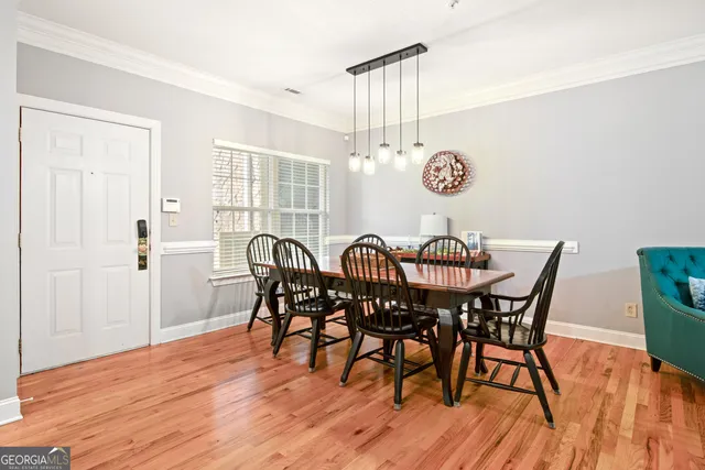 a view of a dining room with furniture and wooden floor
