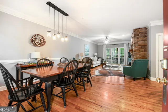 a view of a dining room with furniture and a chandelier