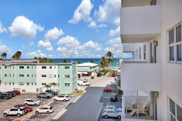 a view of a dining room with furniture and a view of kitchen