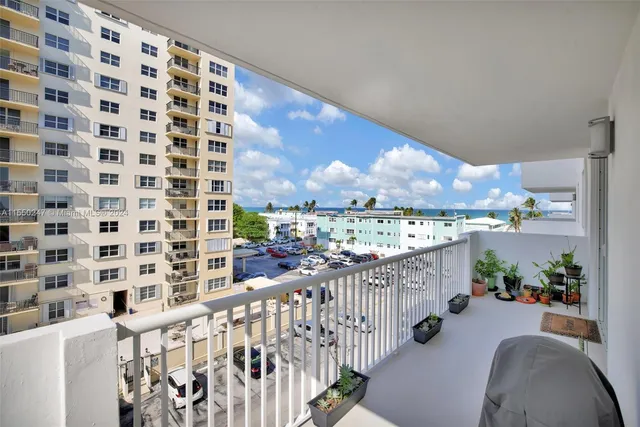 a view of a dining room with furniture a chandelier and window