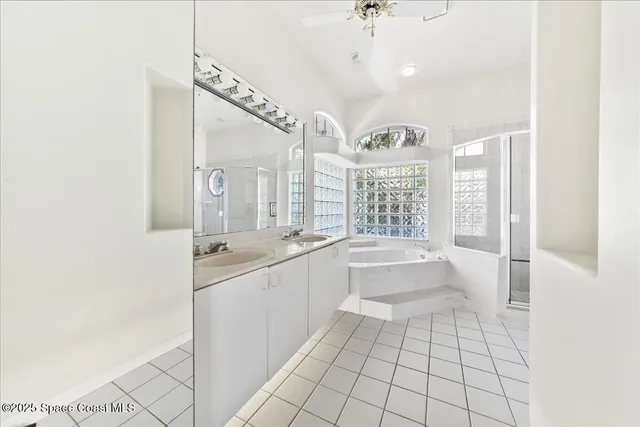 a large white kitchen with a large window