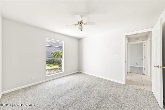 an empty room with windows and entrance