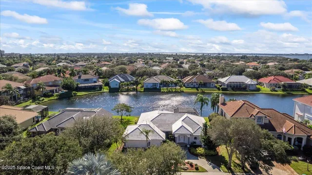 an aerial view of lake and houses with outdoor space