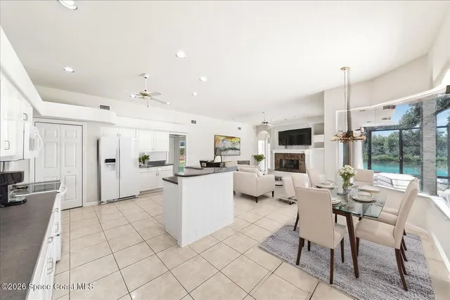 a open kitchen with white cabinets and stainless steel appliances