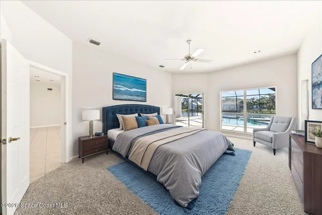 a spacious bedroom with a bed and large windows