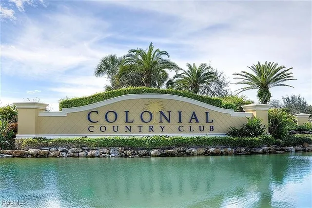 a sign that is on a pole next to a lake