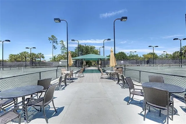 a view of a patio with chairs and plants
