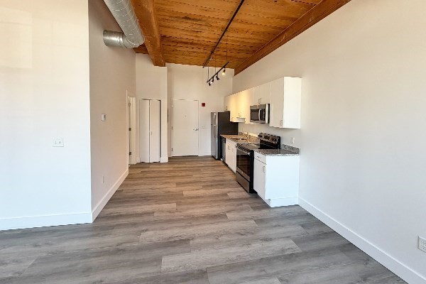 60 Water Street, Unit 2012 North Andover, MA 01845 - Photo 2 of 5 a view of a kitchen with a sink and wooden floor