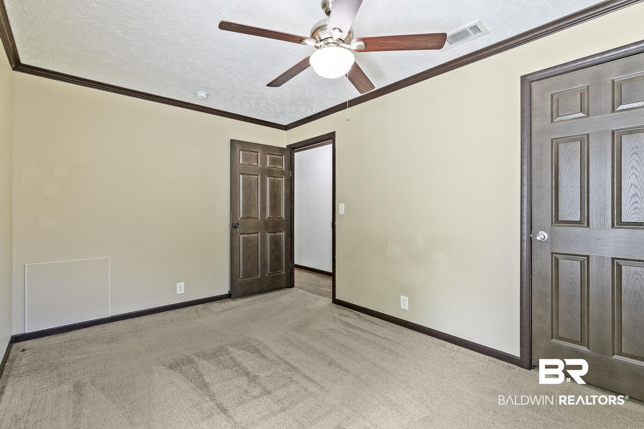 35641 County Road 39 Stapleton, AL 36578 - Photo 25 of 46 Unfurnished bedroom featuring ceiling fan, a textured ceiling, light carpet, and crown molding