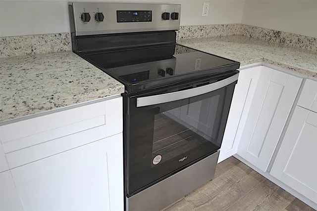 a stove top oven sitting inside of a kitchen