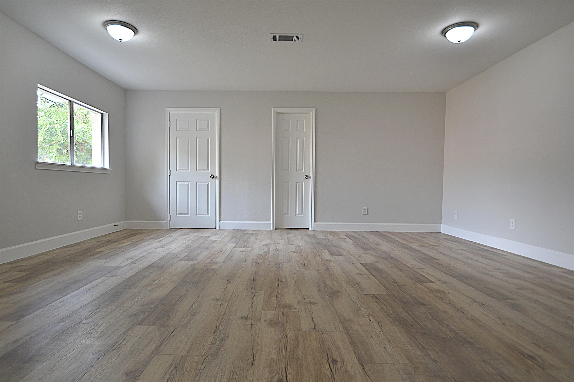 4527 Adonis Drive Spring, TX 77373 - Photo 18 of 32 a view of an empty room with wooden floor and a window