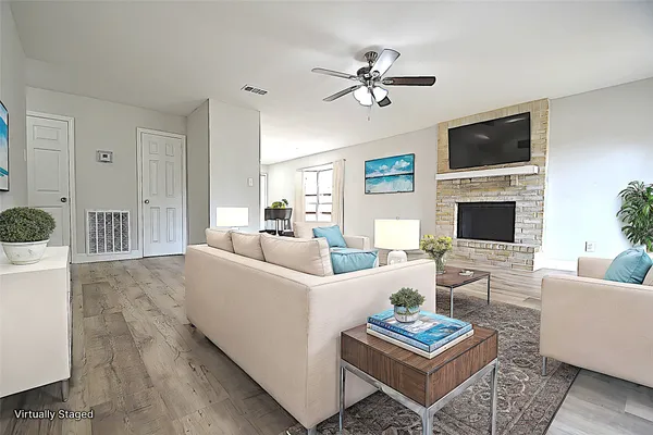 a living room with furniture a fireplace and a flat screen tv
