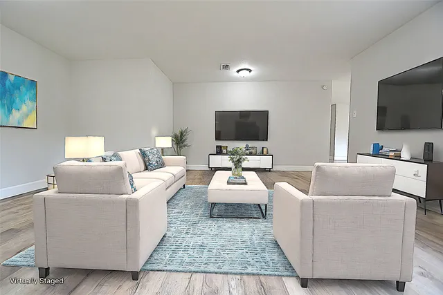 a living room with furniture and a flat screen tv