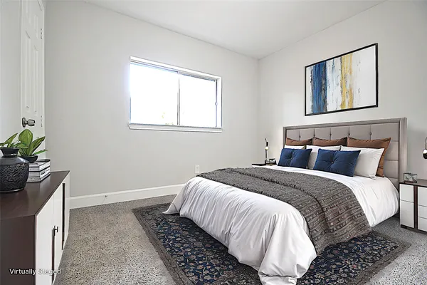 a bedroom with bed and window