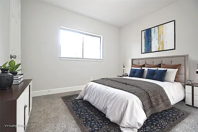 a bedroom with bed and window