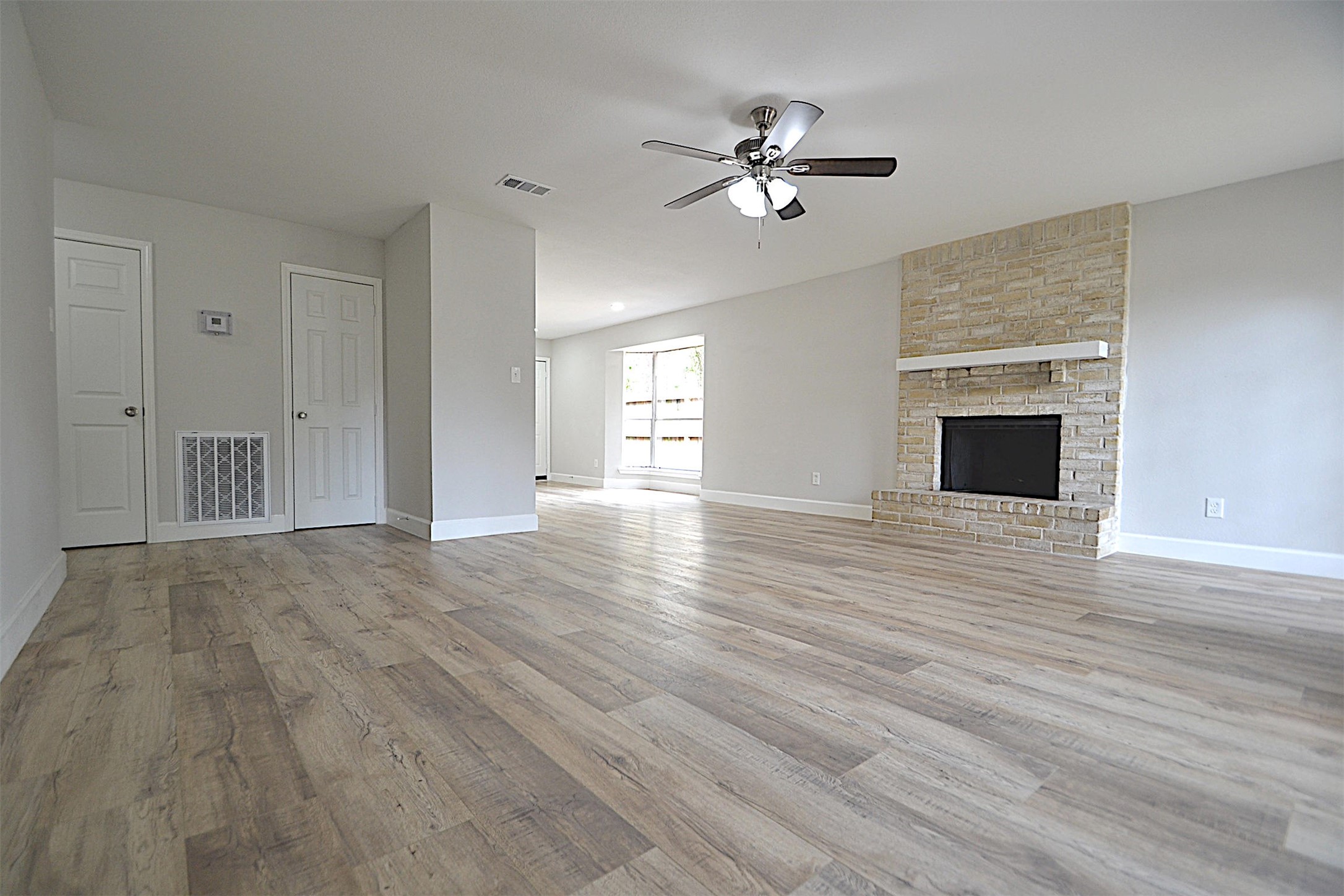 4527 Adonis Drive Spring, TX 77373 - Photo 8 of 32 a view of empty room with wooden floor and fireplace