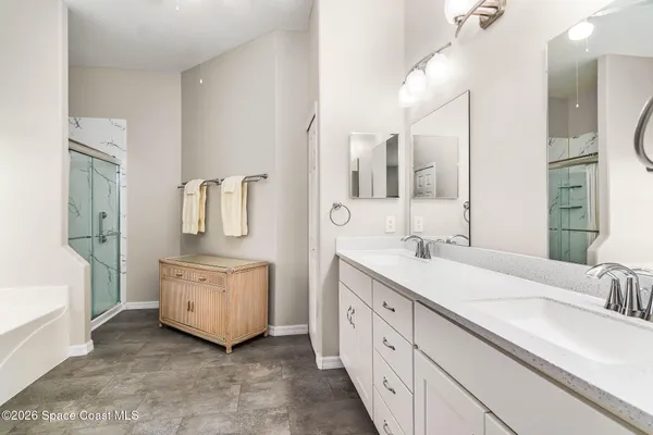 a bathroom with a tub sink and mirror