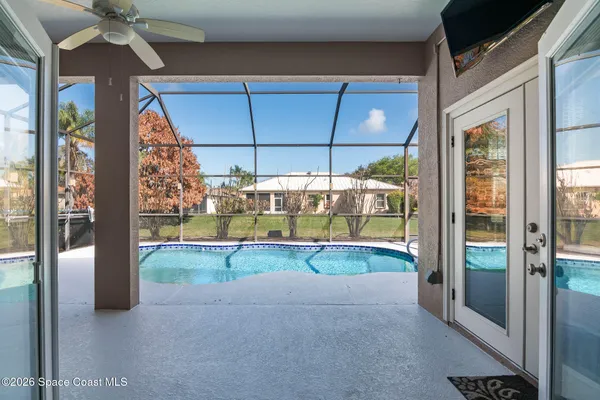 a view of a backyard with swimming pool