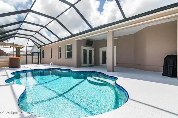 a view of a swimming pool with a lounge chair