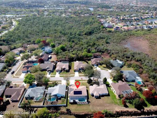an aerial view of multiple houses with a yard