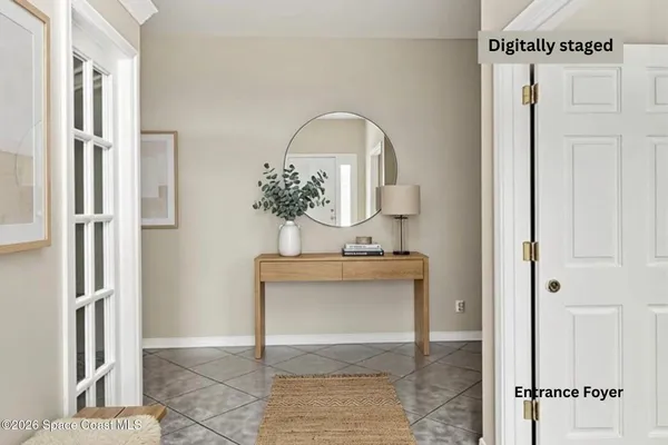 a view of a hallway with bathroom and wooden floor