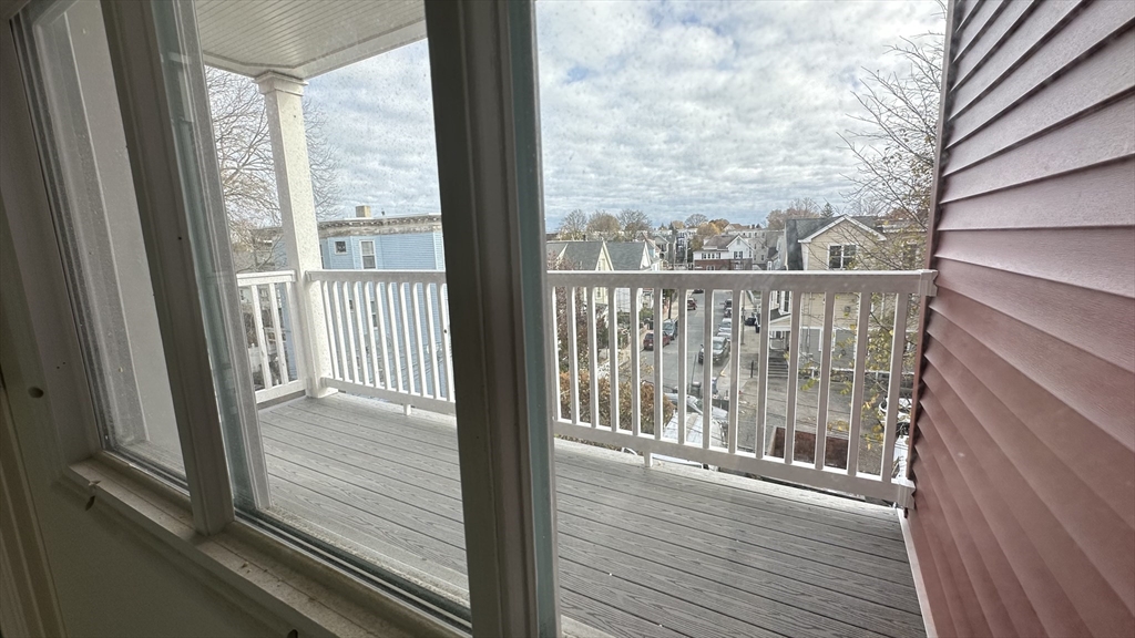 663 Columbia Road, Unit 3 Boston, MA 02125 - Photo 12 of 21 a view of a balcony with wooden floor