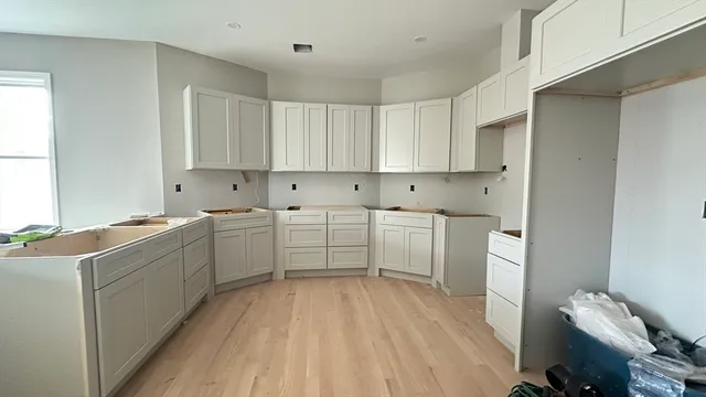 a kitchen with sink a microwave and cabinets