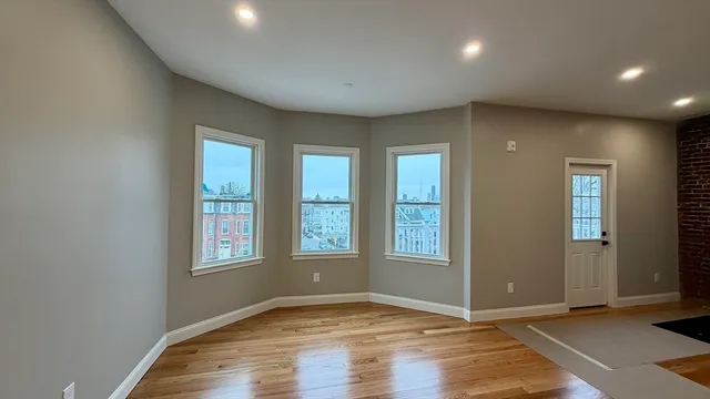 an empty room with windows and closet