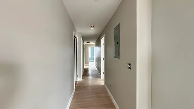 a view of hallway with wooden floor