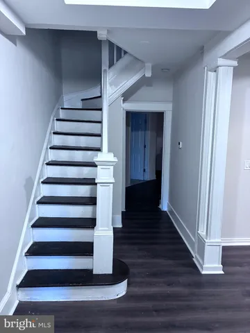 a view of entryway and hall with wooden floor