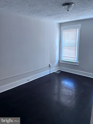 a view of room with hardwood floor and window