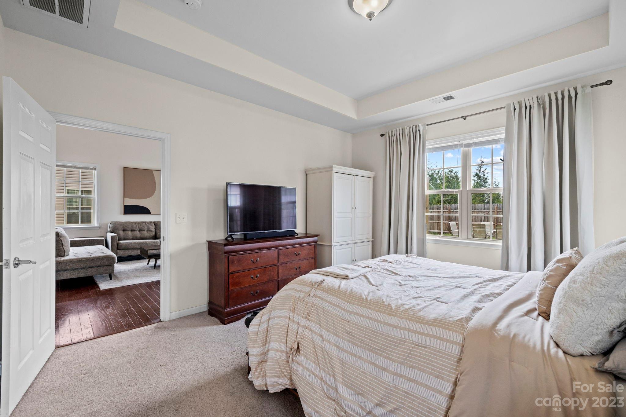 59 North River Road Fletcher, NC 28732 - Photo 13 of 36 a bedroom with a balcony a bed and a flat screen tv