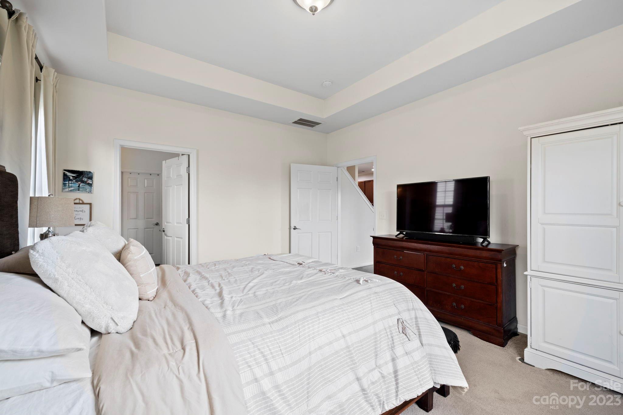 59 North River Road Fletcher, NC 28732 - Photo 14 of 36 a bedroom with a bed and a flat screen tv