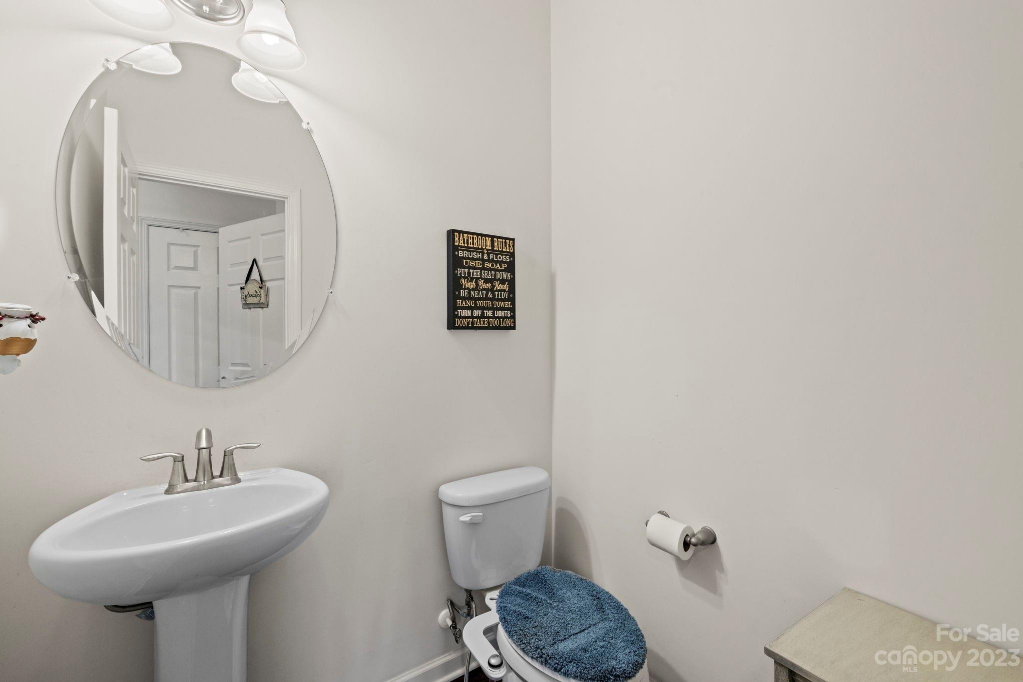 59 North River Road Fletcher, NC 28732 - Photo 18 of 36 a bathroom with a toilet sink and mirror