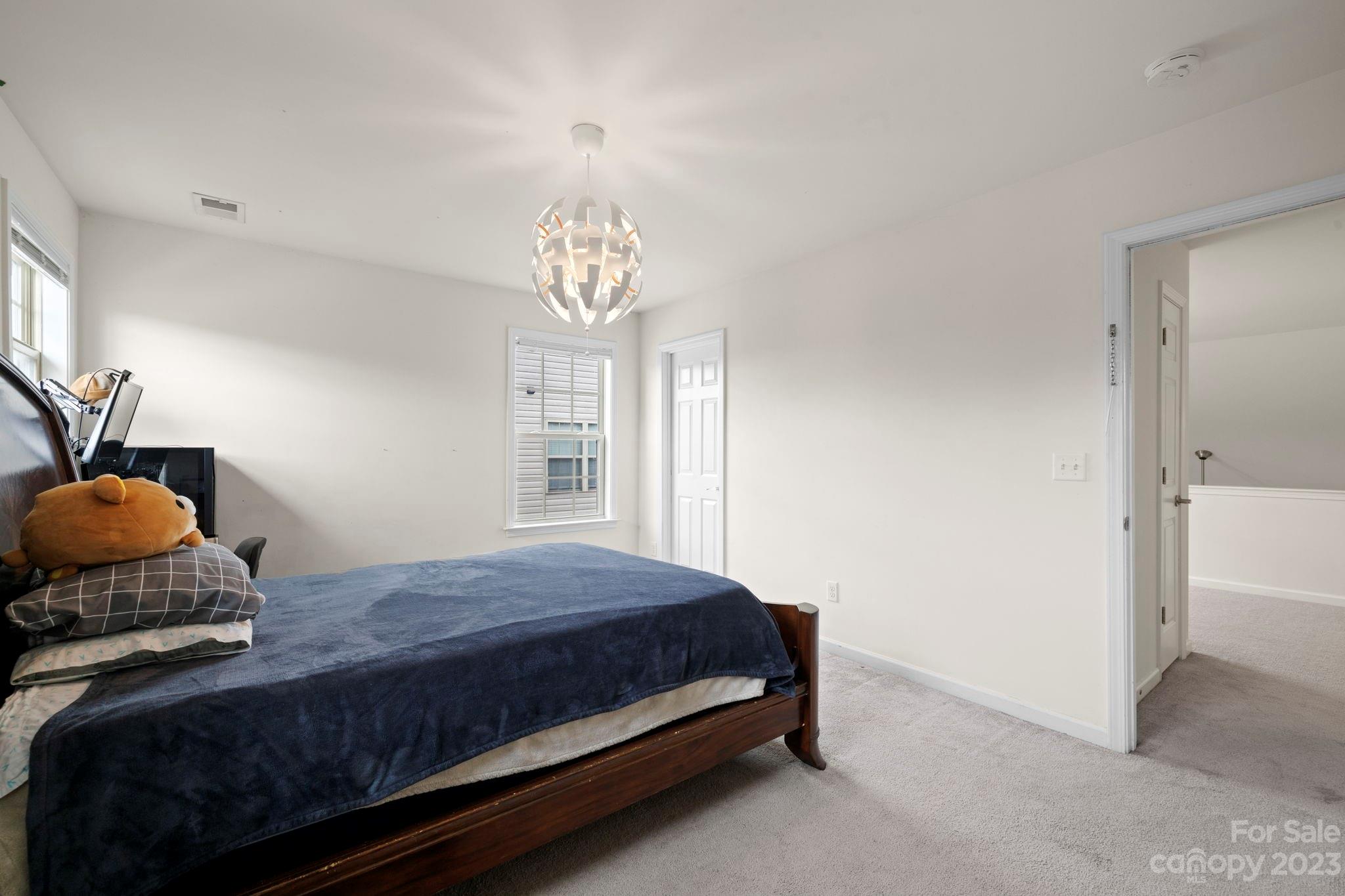 59 North River Road Fletcher, NC 28732 - Photo 28 of 36 a bedroom with a bed and wooden floor