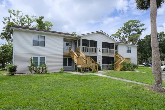 a view of a house with a yard and sitting area