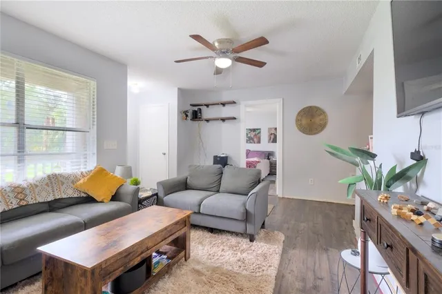 a living room with furniture and wooden floor