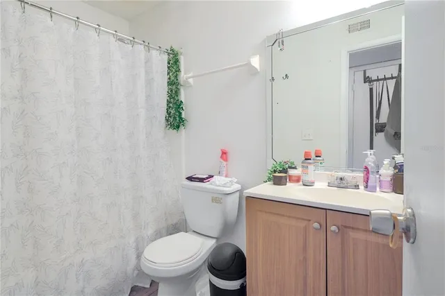 a bathroom with a sink vanity mirror and toilet