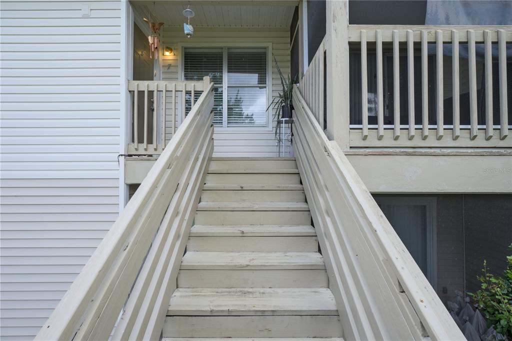 1600 Big Tree Road, Unit A7 South Daytona, FL 32119 - Photo 3 of 22 a view of staircase with lots of frames on wall and a potted plant