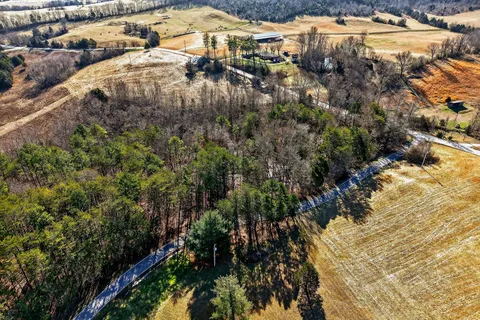 a view of a house with backyard and wooden fence