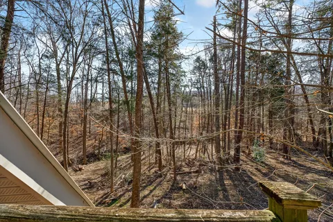 a backyard of a house with barbeque oven table and chairs