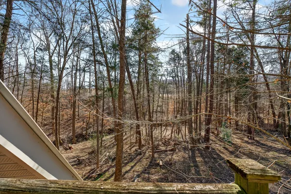 a backyard of a house with barbeque oven table and chairs