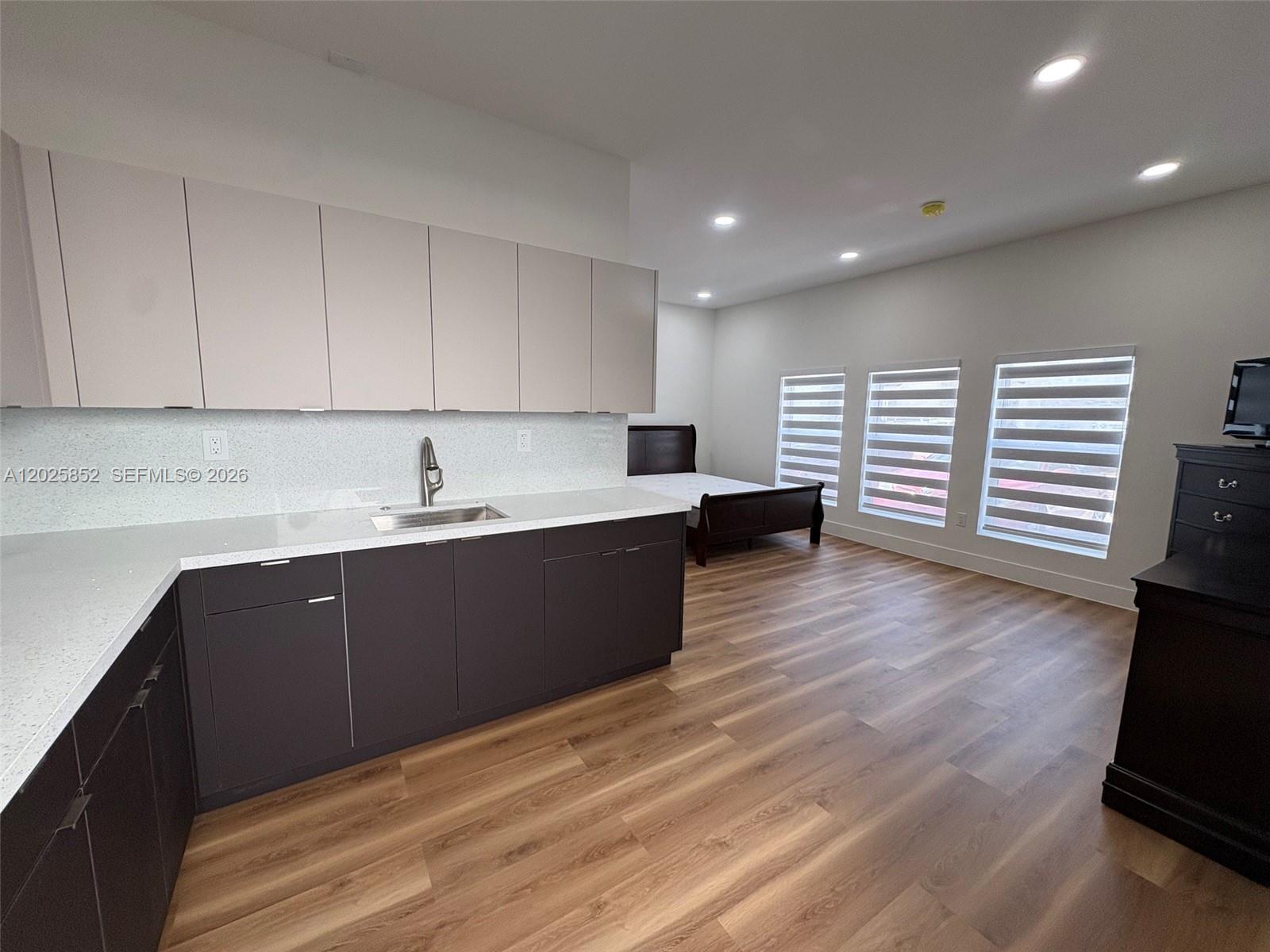 12948 Southwest 265th Terrace, Unit STUDIO Homestead, FL 33032 - Photo 1 of 16 a kitchen with stainless steel appliances granite countertop a sink a stove and cabinets