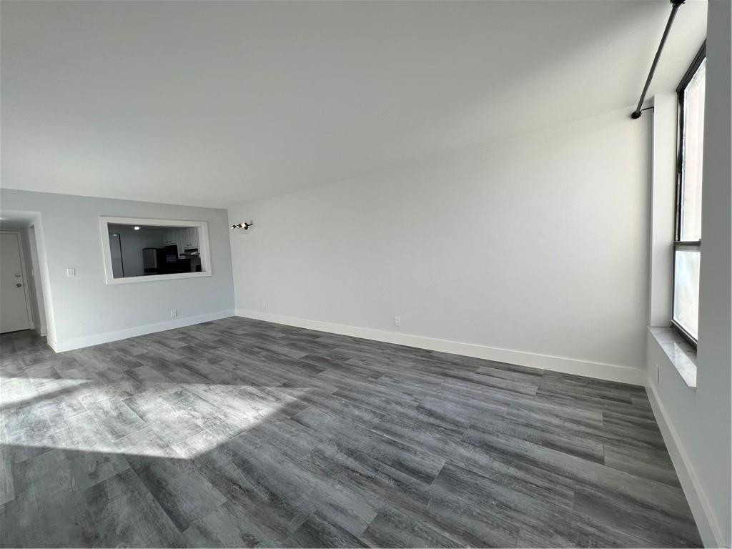 6451 North University Drive, Unit 112 Tamarac, FL 33321 - Photo 11 of 21 a view of a livingroom with wooden floor and window