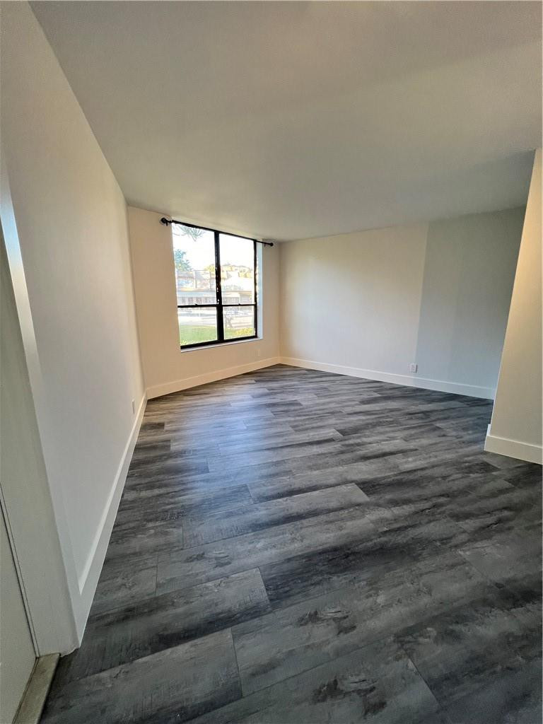 6451 North University Drive, Unit 112 Tamarac, FL 33321 - Photo 16 of 21 wooden floor in an empty room with a window