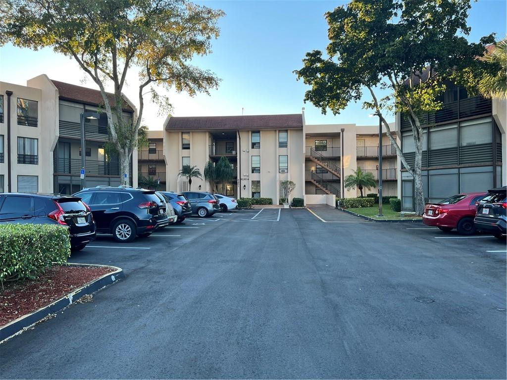 6451 North University Drive, Unit 112 Tamarac, FL 33321 - Photo 3 of 21 a view of a cars parked in front of a building