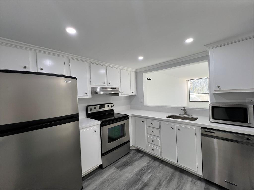 6451 North University Drive, Unit 112 Tamarac, FL 33321 - Photo 7 of 21 a kitchen with stainless steel appliances a sink stove and refrigerator