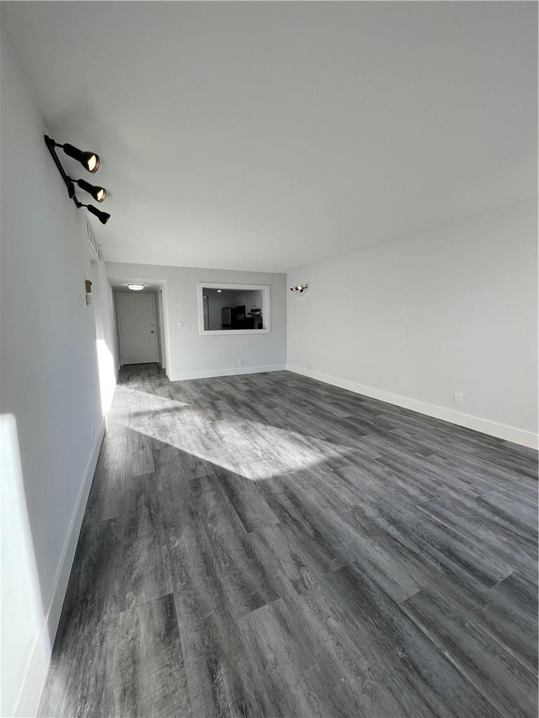 6451 North University Drive, Unit 112 Tamarac, FL 33321 - Photo 10 of 21 a view of empty room with wooden floor and fan
